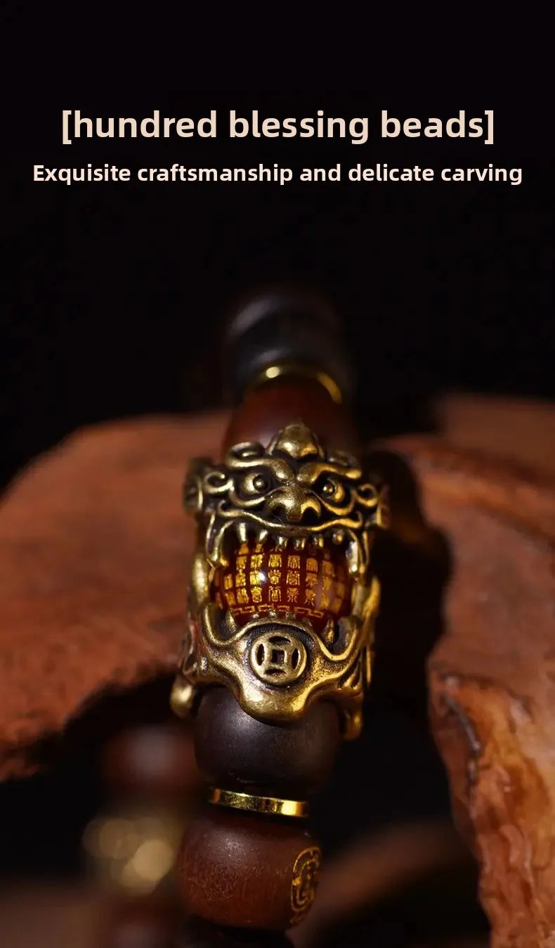 A close-up of a handcrafted Thunder-Wood Pixiu bracelet featuring gold-toned metalwork and semi-jade beads.