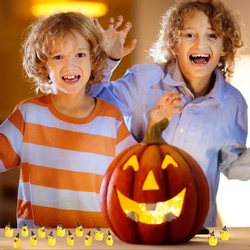Two children smiling while holding a carved pumpkin and miniature resin witch hat ducks for crafting