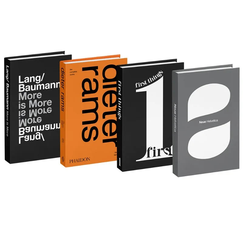 A set of four decorative faux books with black, orange, and gray spines displayed side by side.