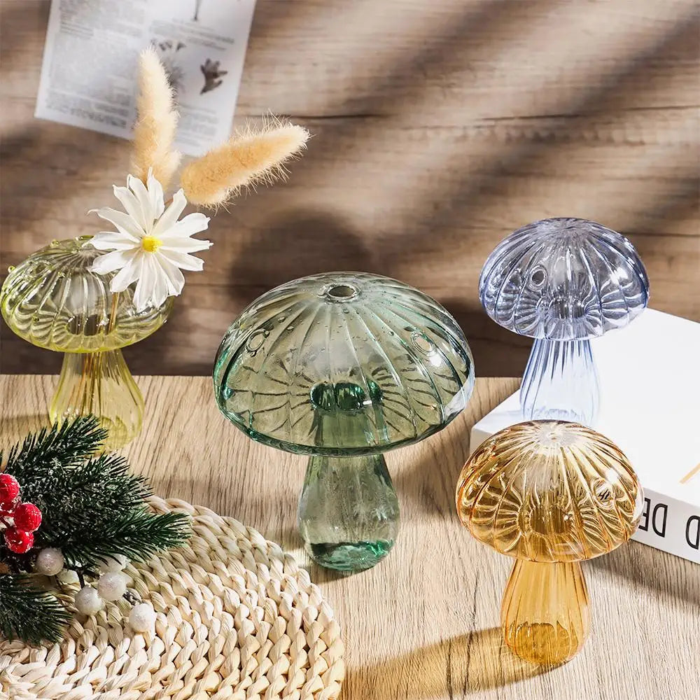 A collection of mushroom-shaped glass vases in translucent jelly colors, including green and amber tones.