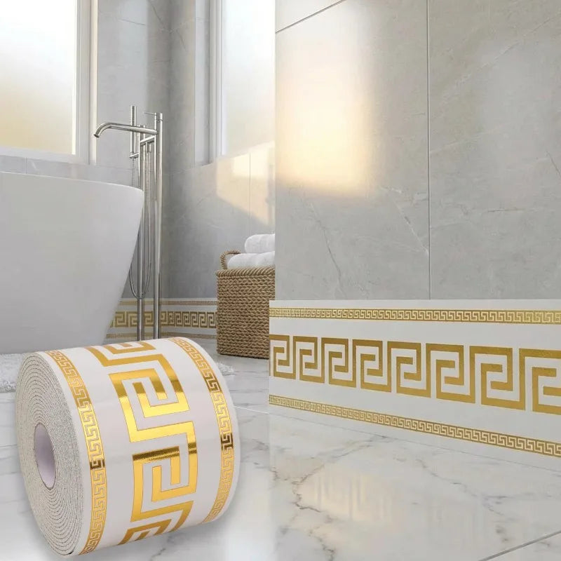 Roll of self-adhesive PVC skirting board trim with a gold and white Greek key pattern on a marble floor.