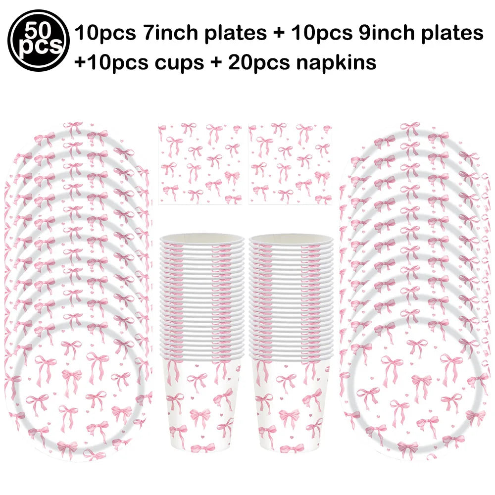 A set of pink bow disposable party tableware including 7 inch and 9 inch plates, cups, and napkins.