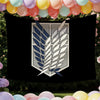A dark banner featuring a silver and blue crest design of stylized wings surrounded by pink and yellow balloons.