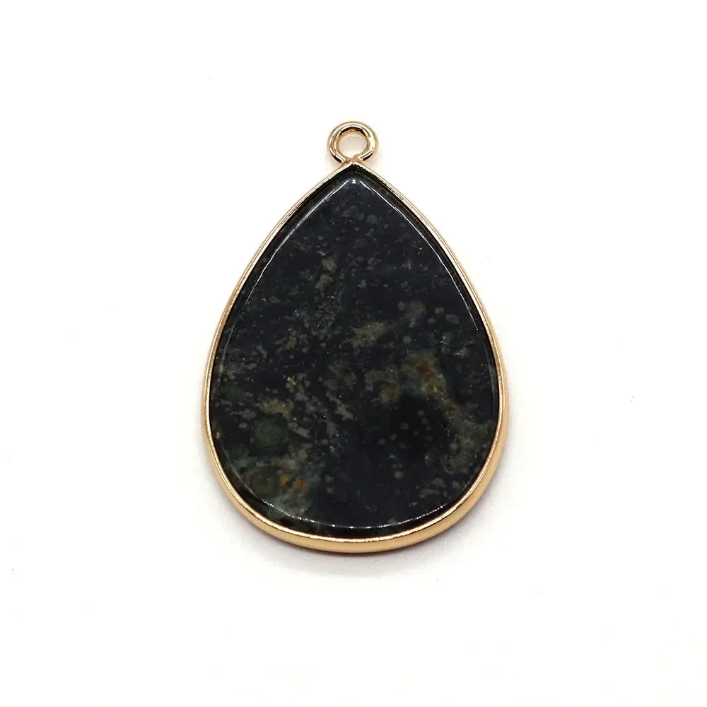 A teardrop-shaped black natural agate pendant with a gold-colored bail.