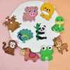A collection of twelve soft pastel animal fridge magnets featuring various cute animals like a pig, lion, monkey, and frog.