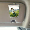 A car sunshade photo frame with a magnetic visor clip holder displaying a couple outdoors.
