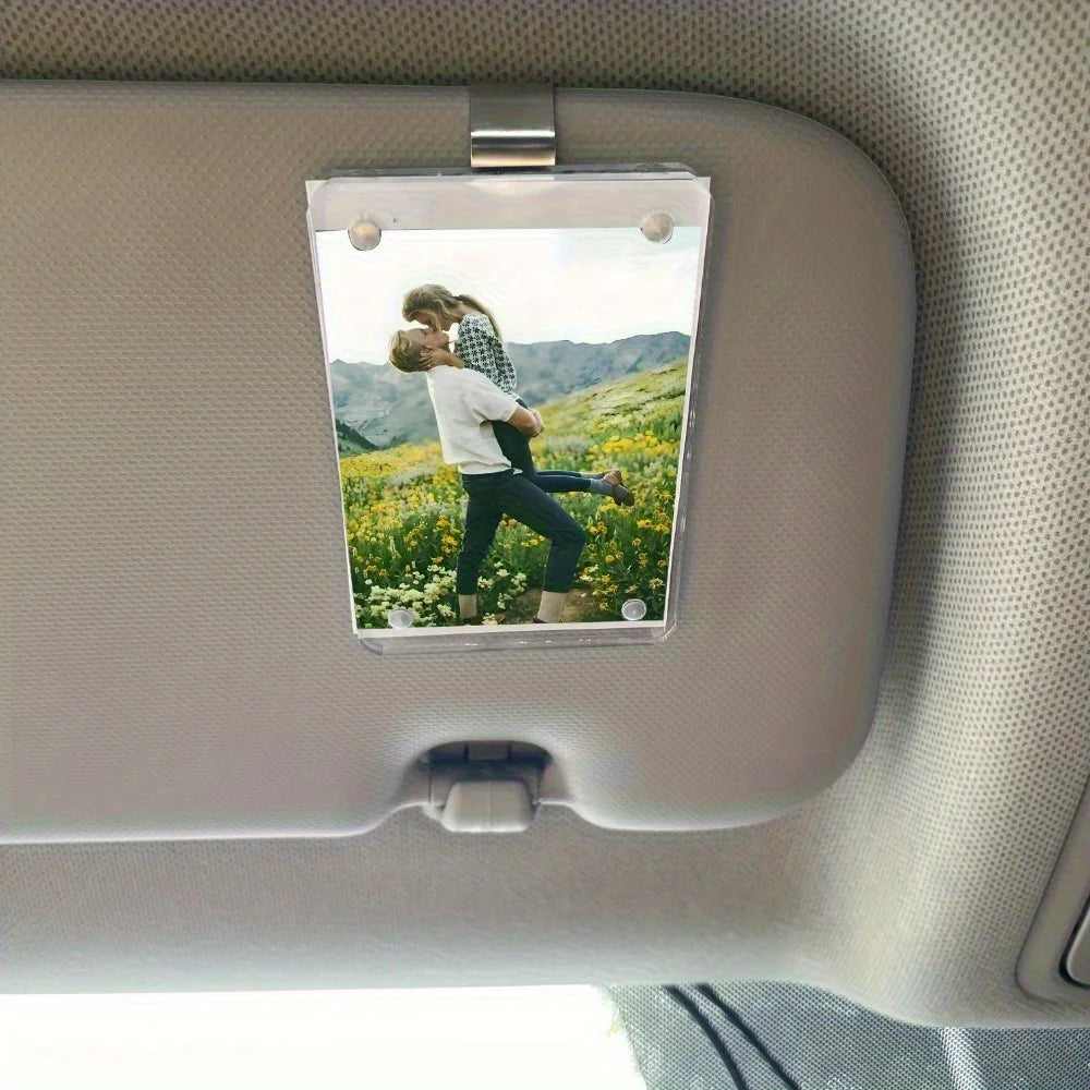 A car sunshade photo frame with a magnetic visor clip holder displaying a couple outdoors.