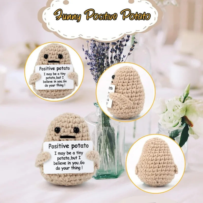 A handmade beige knitted plush potato doll with a smiling face displayed in a clear glass.