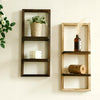 A rustic wooden floating shelf with two tiers displaying a potted plant and a white candle.