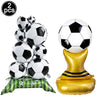 Two inflated white and black soccer balls are displayed on a gold foil stand for party decoration
