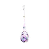 A long, translucent decoration shaped like a spider with glowing light-up eggs.