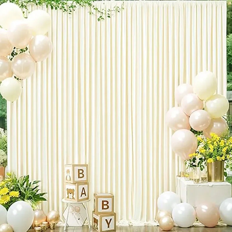 Elegant rectangular backdrop drapes in cream fabric decorated with white and blush balloons and greenery