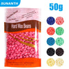 A package of hard wax beans for beauty skin hair removal showing pink and blue colored beads.