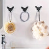 A set of five black gothic bat adhesive hooks for hanging keys and bags on a white wall.