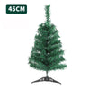 A small, green artificial Christmas tree with lights on a stand.