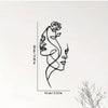Black metal line art of a woman's profile, measuring 30 cm high.