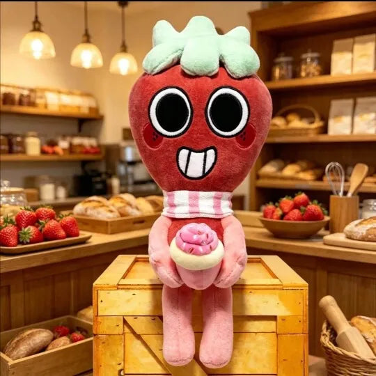 A plush doll resembling a red, slightly monstrous face with large black eyes and white teeth, standing in front of wooden she