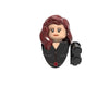A building block figure of a woman with long reddish hair wearing a dark outfit.