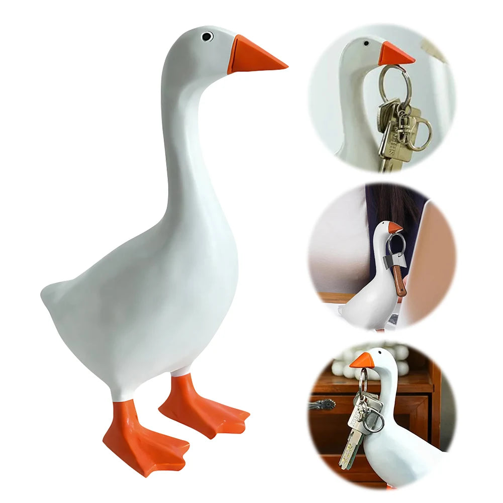 White resin goose figurine with an orange beak and a key holder feature.