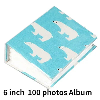 A teal photo album featuring a pattern of white cartoon pandas.