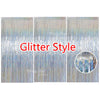 Three panels of silver glitter foil fringe curtains used for party backdrop decor