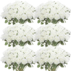 A collection of white artificial silk roses arranged in bouquets for table decor.