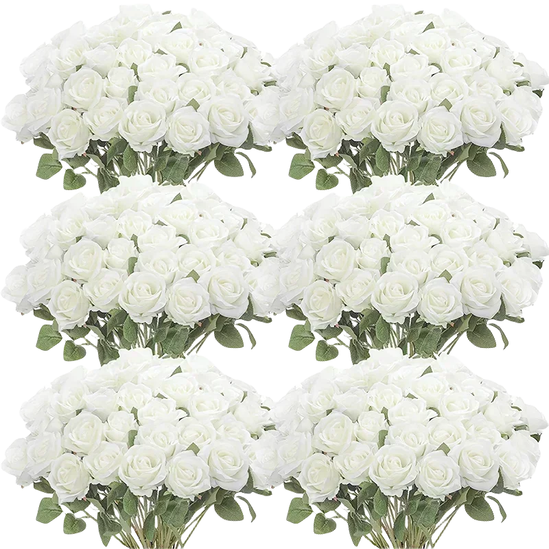 A collection of white artificial silk roses arranged in bouquets for table decor.