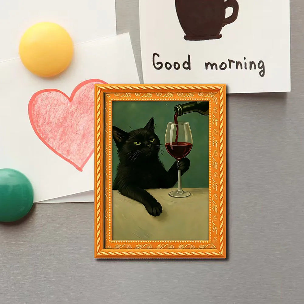 A framed magnet featuring a black cat drinking from a glass of red wine.