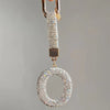 A sparkling crystal letter keychain charm hanging from a gold-toned clasp.