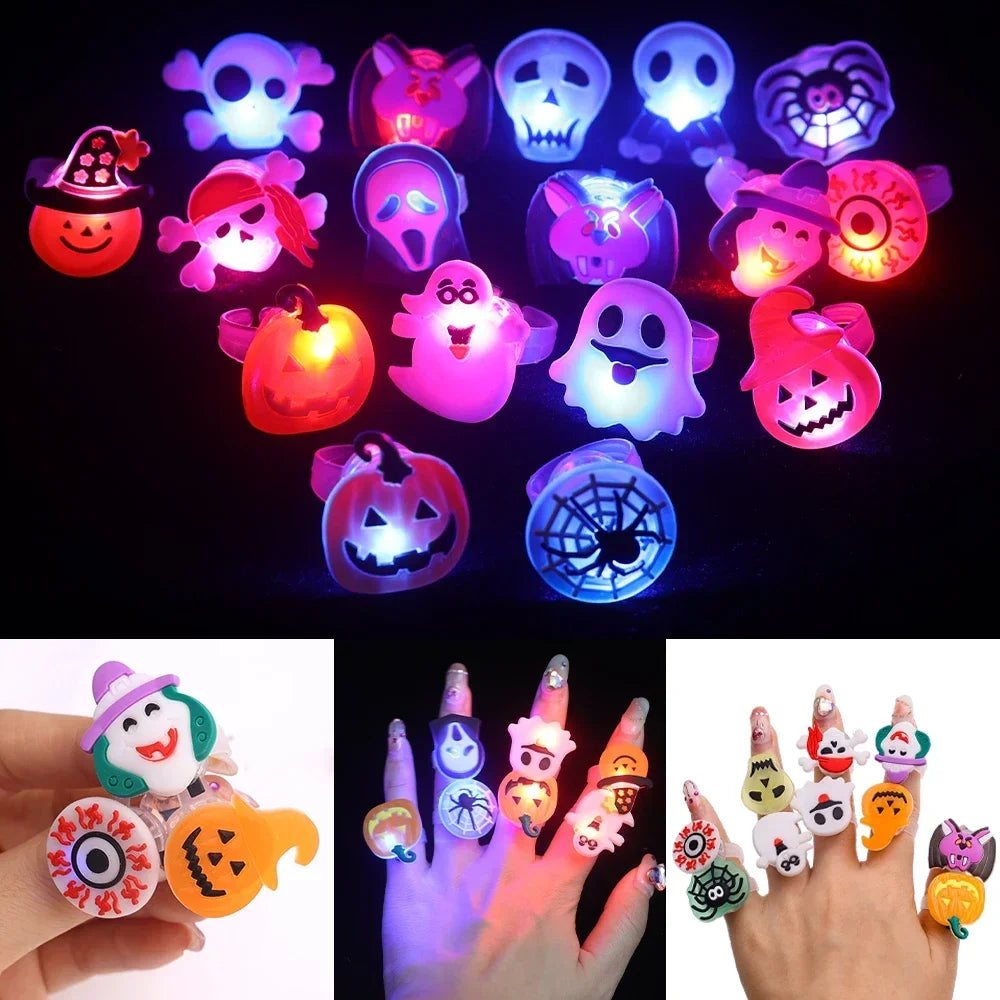 A collection of glow-in-the-dark Halloween rings with flashing lights displayed on a dark background.