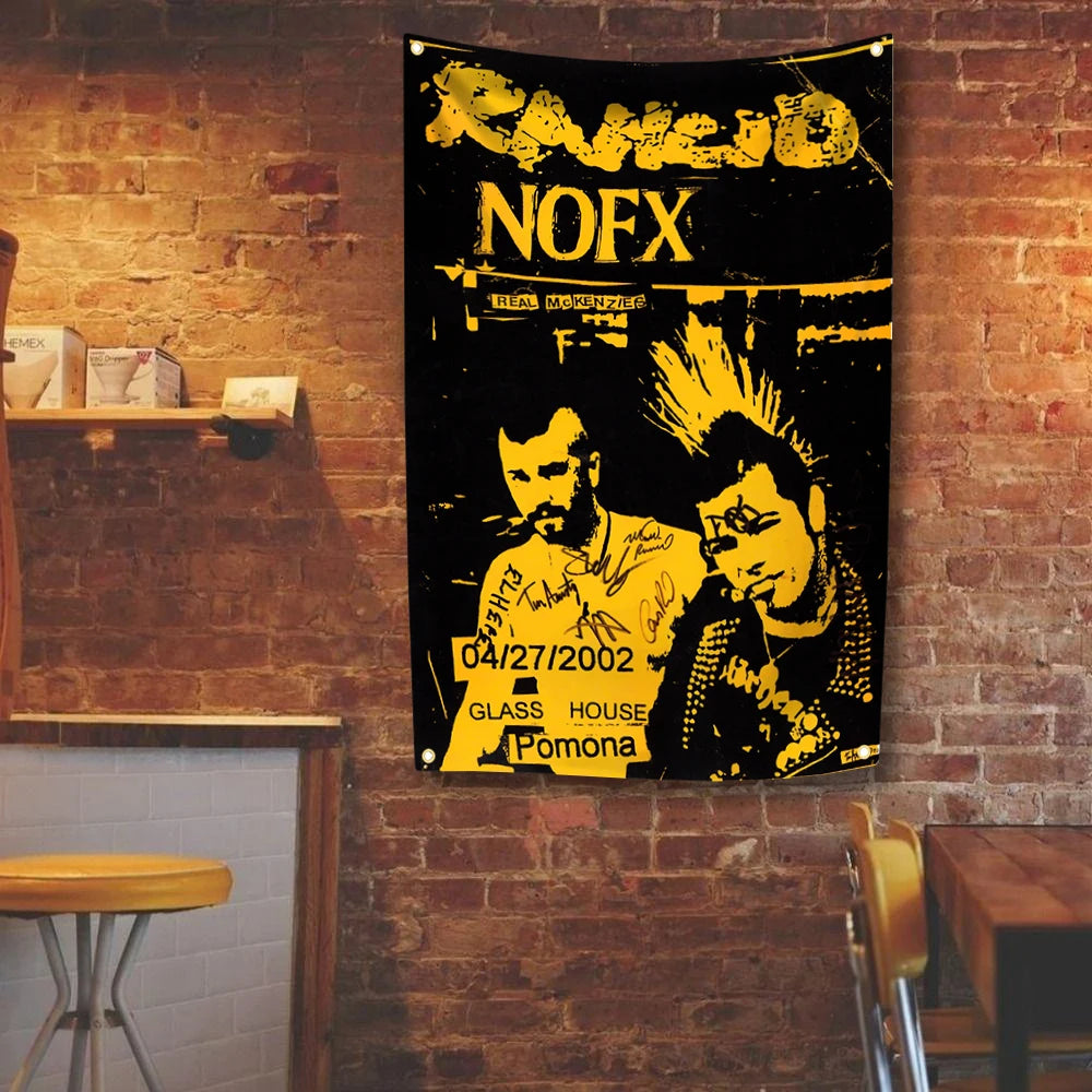 A black tapestry featuring the text RAMOID NOFX and related band imagery displayed on a brick wall.