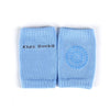 A pair of light blue knitted kids socks with a circular pattern on the front.