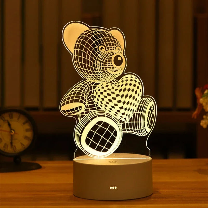 A glowing acrylic night light shaped like a teddy bear and heart, powered by a USB connection.