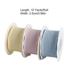 Roll of decorative fishtail yarn ribbon in yellow, pink, and blue colors