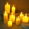A collection of glowing yellow candles in glass holders creating a warm, ambient light.
