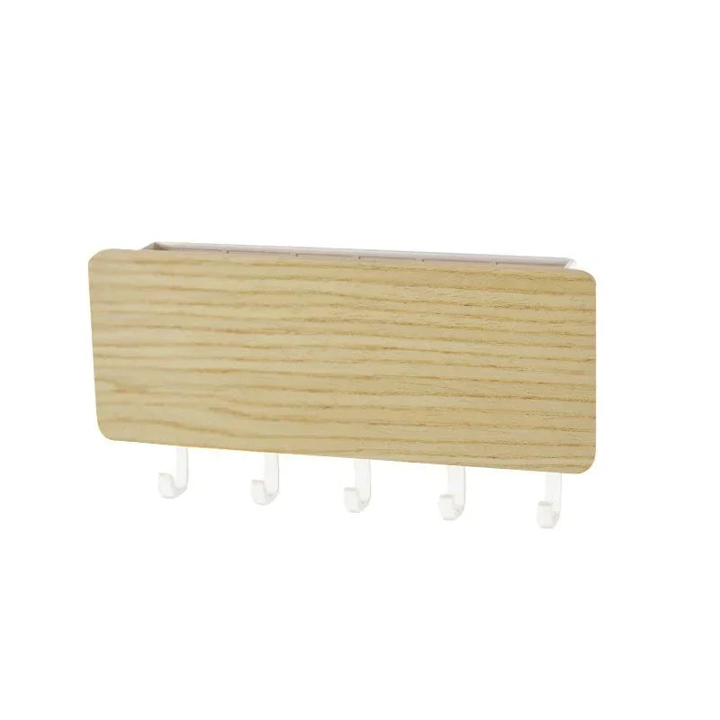 A light wood bamboo wall-mounted key rack with six hooks.