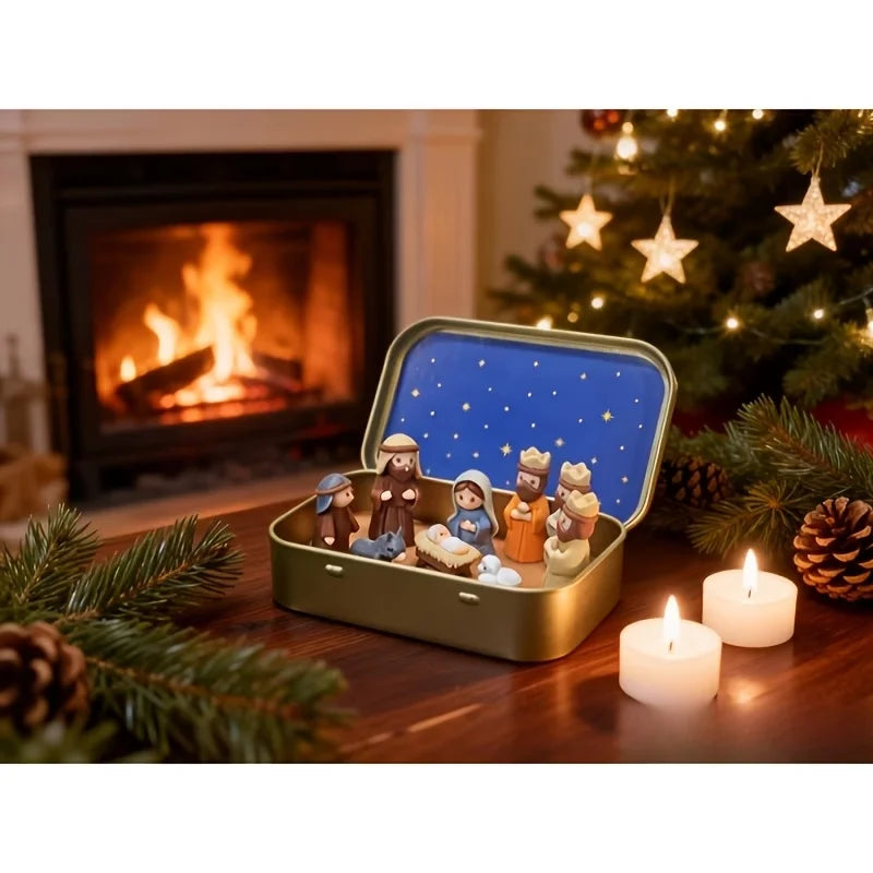 Miniature nativity scene set featuring Mary, Jesus, shepherd, and animal figurines displayed in an open gold-colored box.