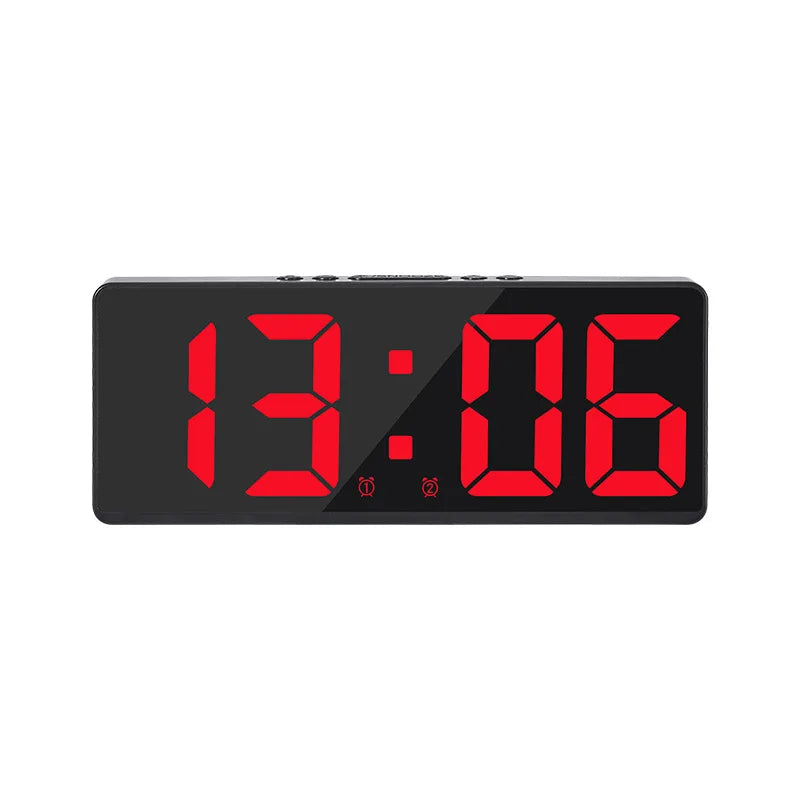 A black digital alarm clock displaying the time 13:06 with red LED digits.