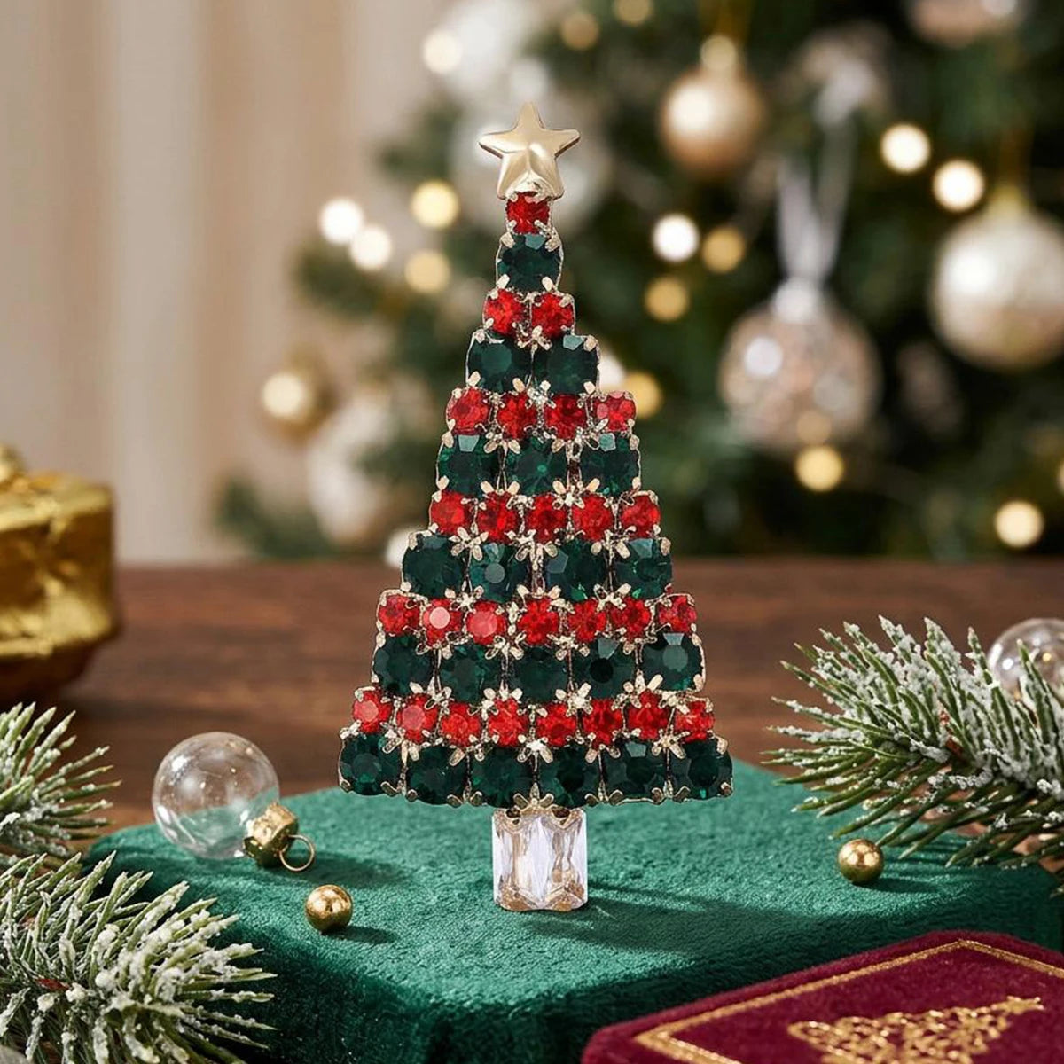 A festive green Christmas tree adorned with red and green rhinestones sits on a dark green velvet fabric.
