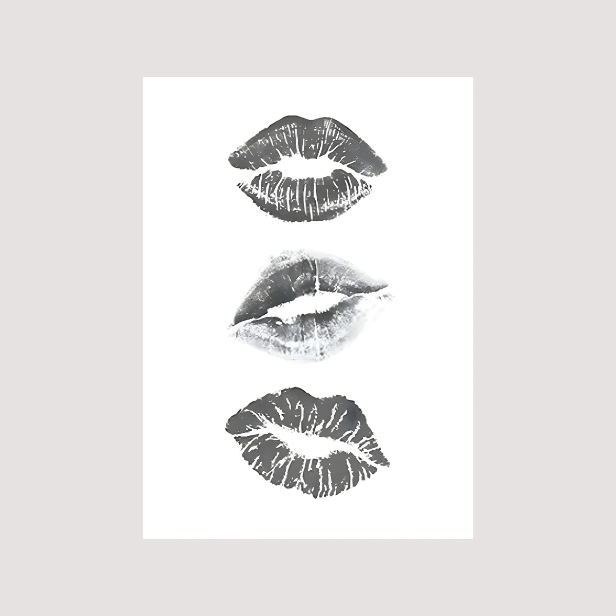 Three grayscale abstract prints of lips with textured strokes on a white background