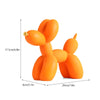 An orange resin sculpture shaped like a dog, used for modern home decor.