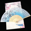 A vintage silk folding fan featuring delicate pink and blue floral patterns on a light background.