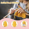 A hand knitting a yellow knitted duck plush toy with an inspirational card.