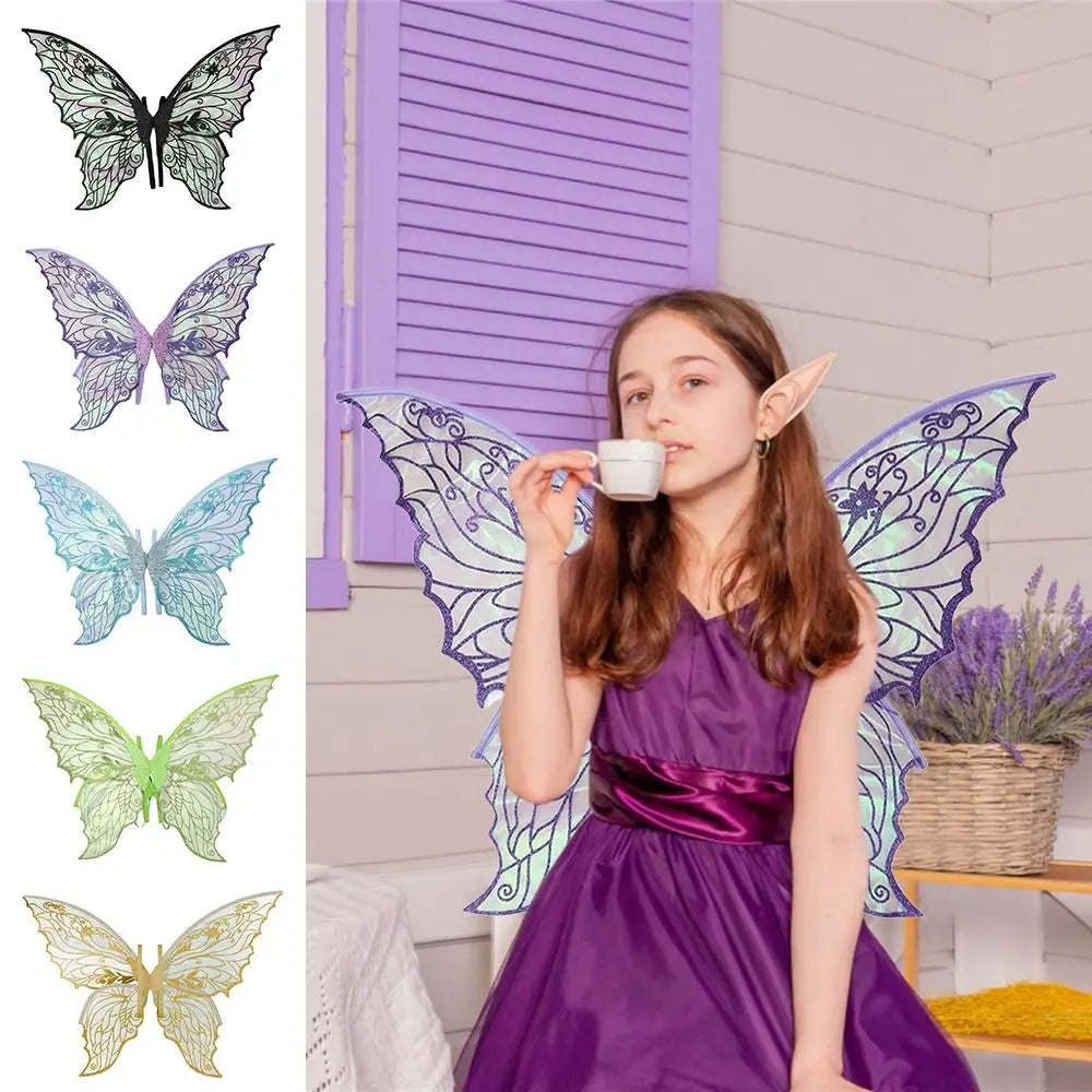 A girl wearing a purple dress and sparkling fairy wings with iridescent details, posing indoors.