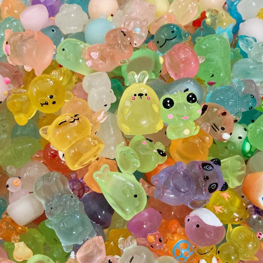 A close-up of a pile of glow-in-the-dark fruit turtle resin charms in various colors and shapes.