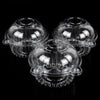 A set of clear plastic cupcake boxes with lids displayed against a black background.