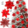 A collection of six red glittered artificial Christmas flowers with clips displayed against a snowy evergreen tree.
