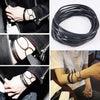 A collection of ten black silicone bracelets with gold accents are shown on wrists and in a coiled arrangement.