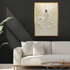 A framed canvas art print depicting Jesus walking on water in white and gold tones, displayed above a light sofa.