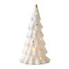 A white ceramic glow-in-the-dark mini Christmas tree decor with a gold topper.